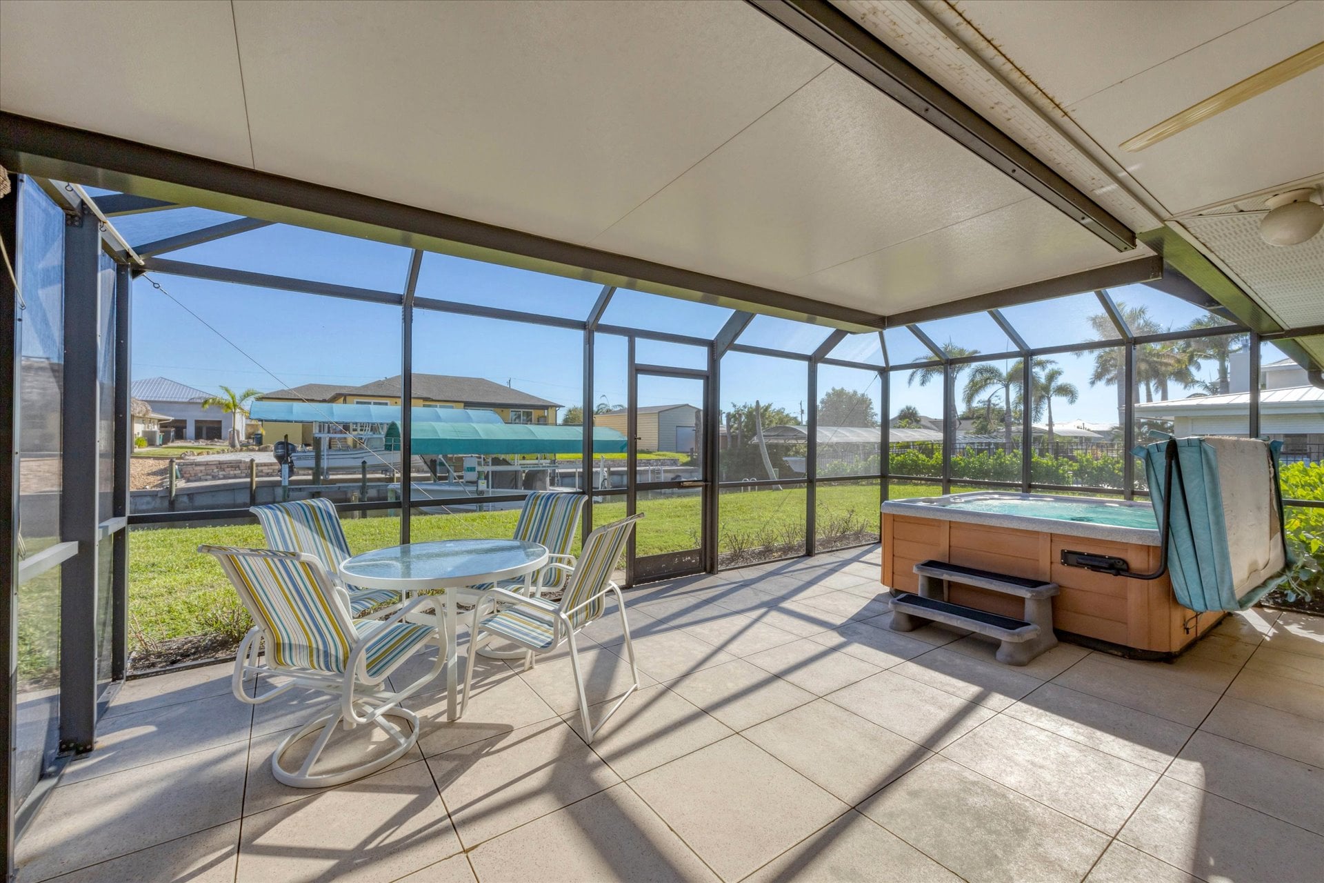 Screened-in patio overlooking the canal with private hot tub that seats 6