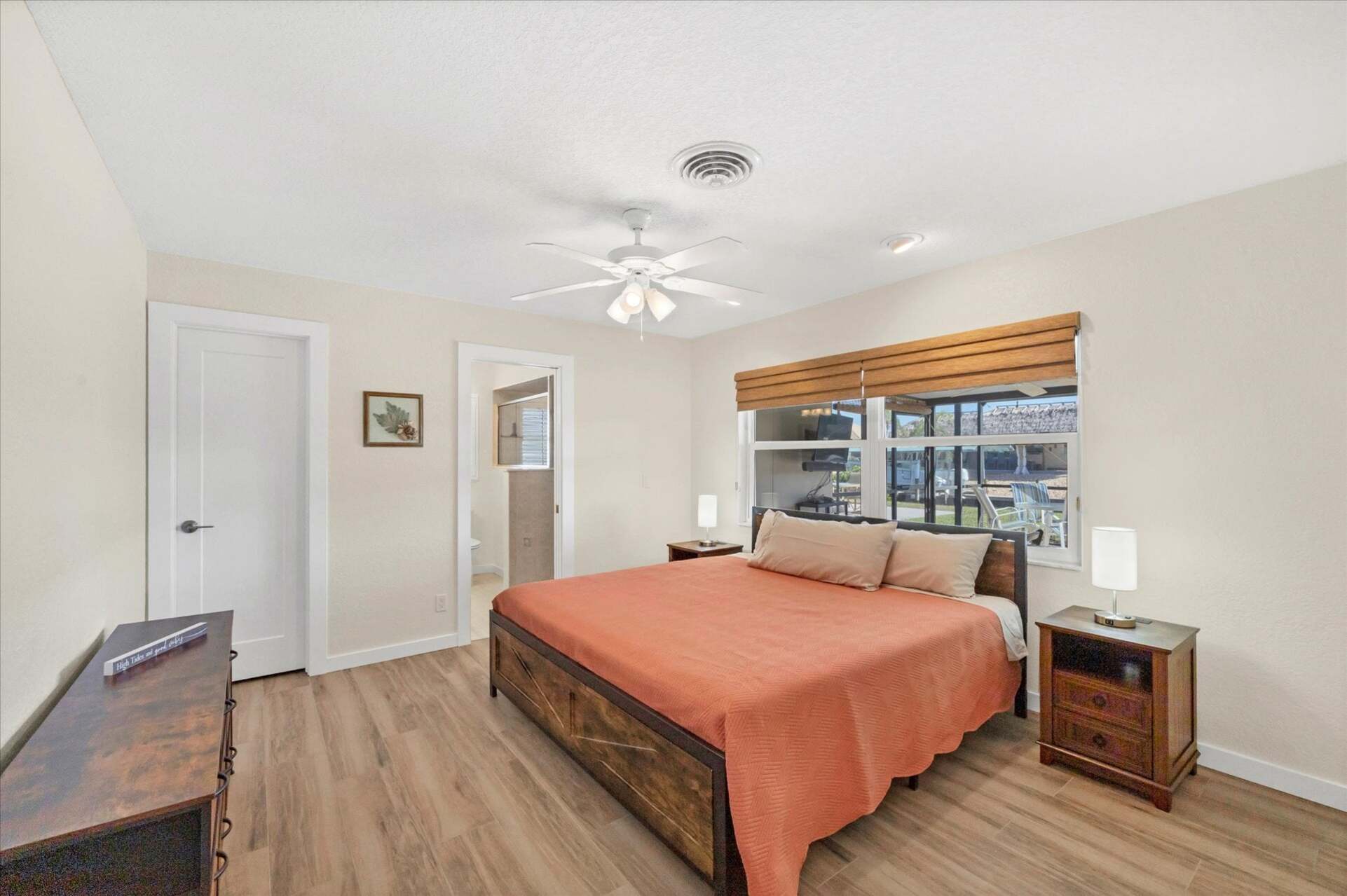 Primary bedroom with king bed, and attached bathroom