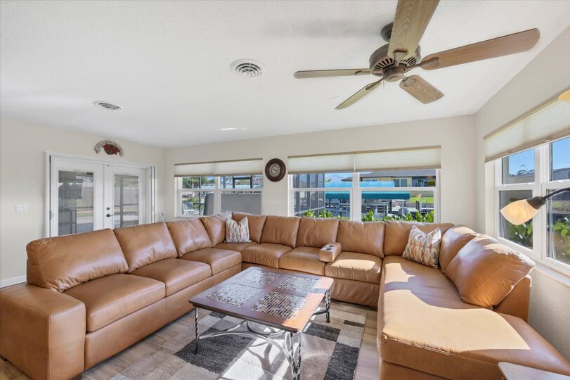 Bright, open living space. Livingroom features large sectional sofa and 50-inch Smart TV