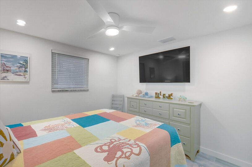 Bedroom 2 with queen bed and 55-inch Smart TV