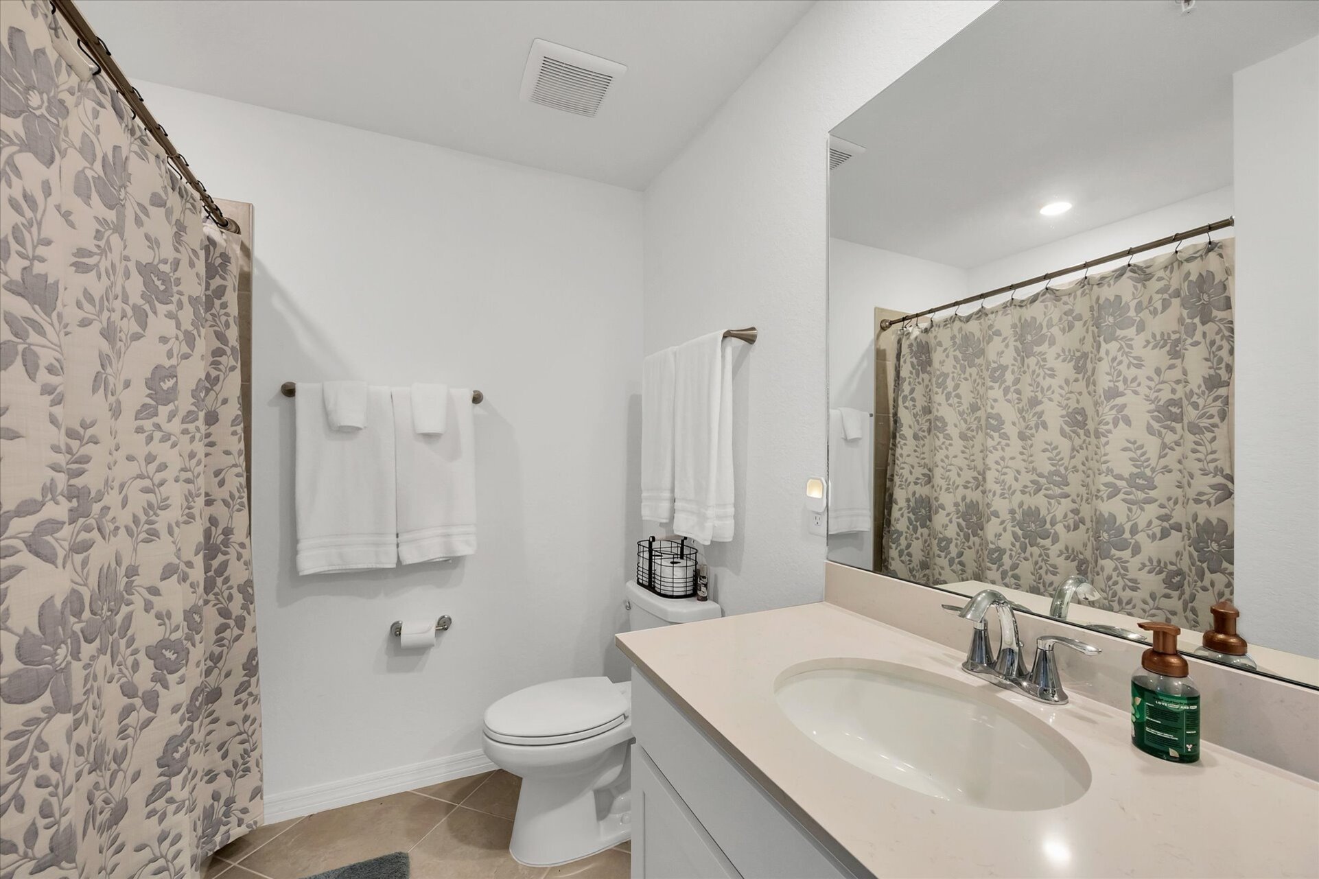 Primary attached bathroom with walk-in shower and double vanities