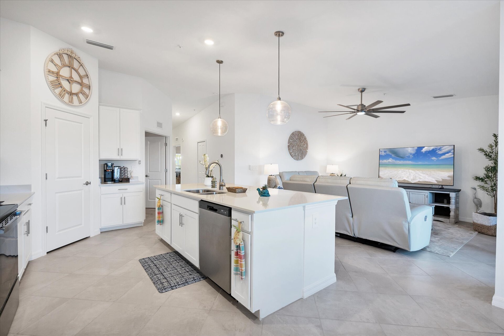 Fully-equipped kitchen over looking living room and dining area