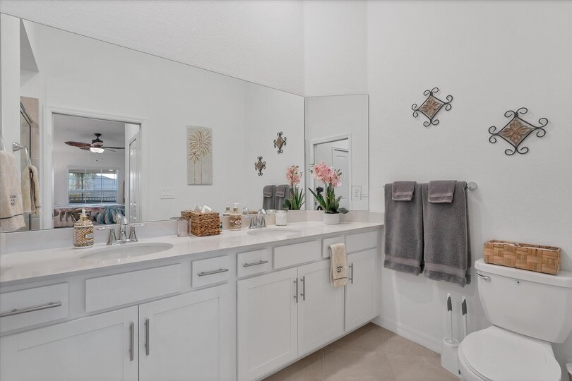 En suite with walk-in shower and double vanities