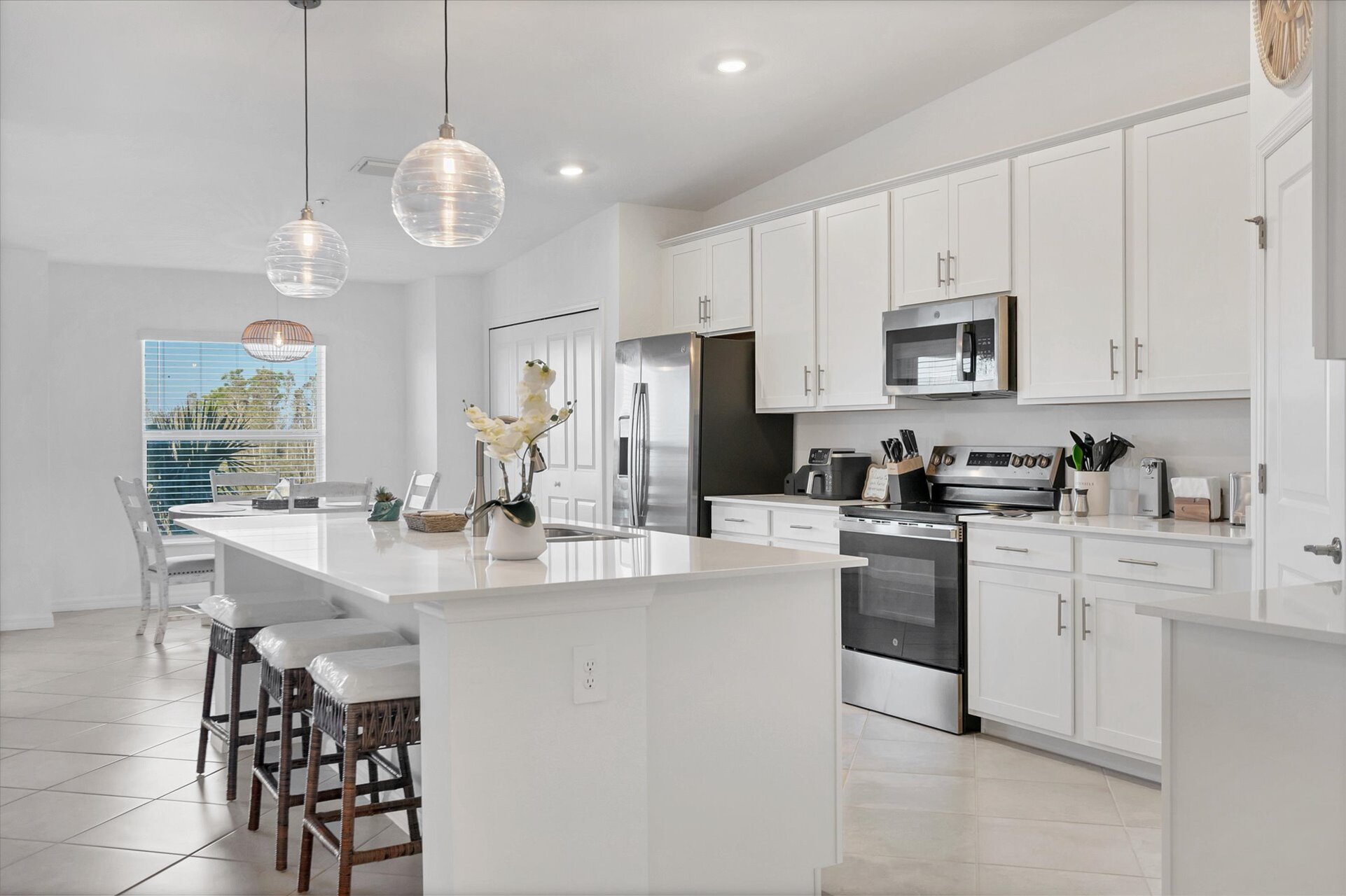 Fully-equipped kitchen over looking living room and dining area