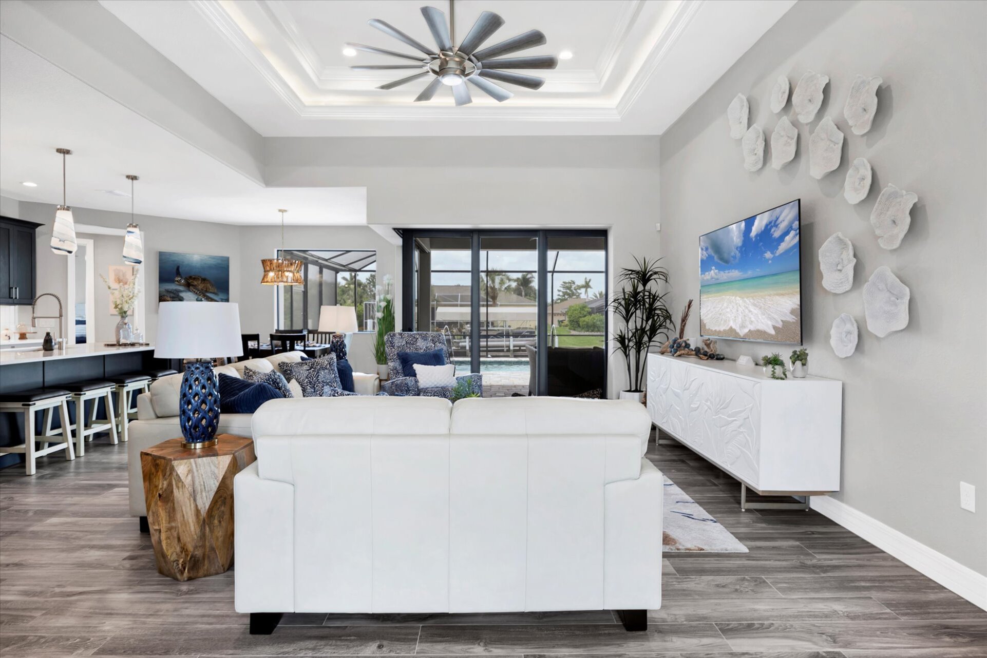 Beautiful, bright, open living space overlooking the sparkling pool and canal beyond