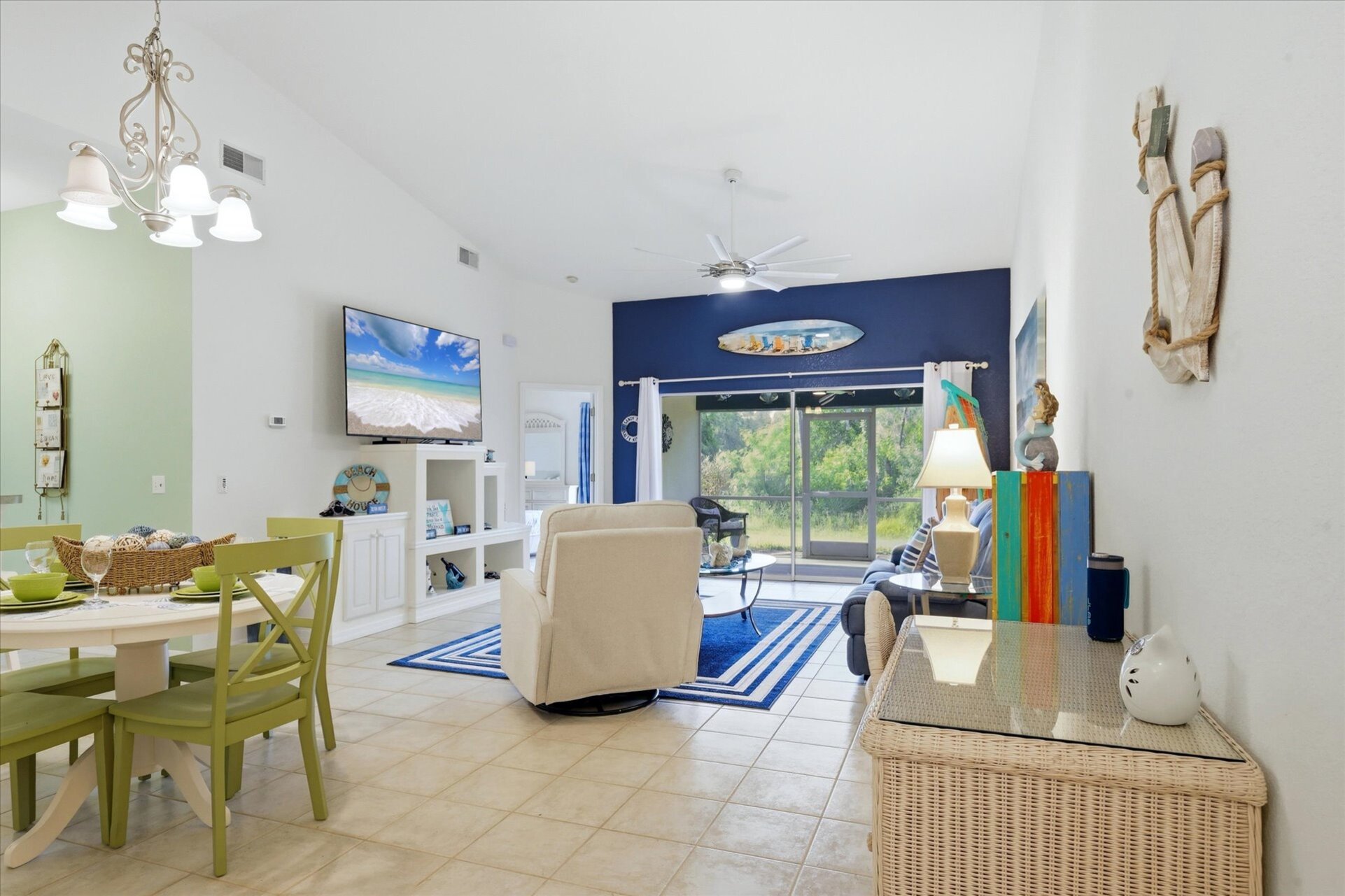 Large living space includes patio access overlooking the pond, and 75-inch Smart TV