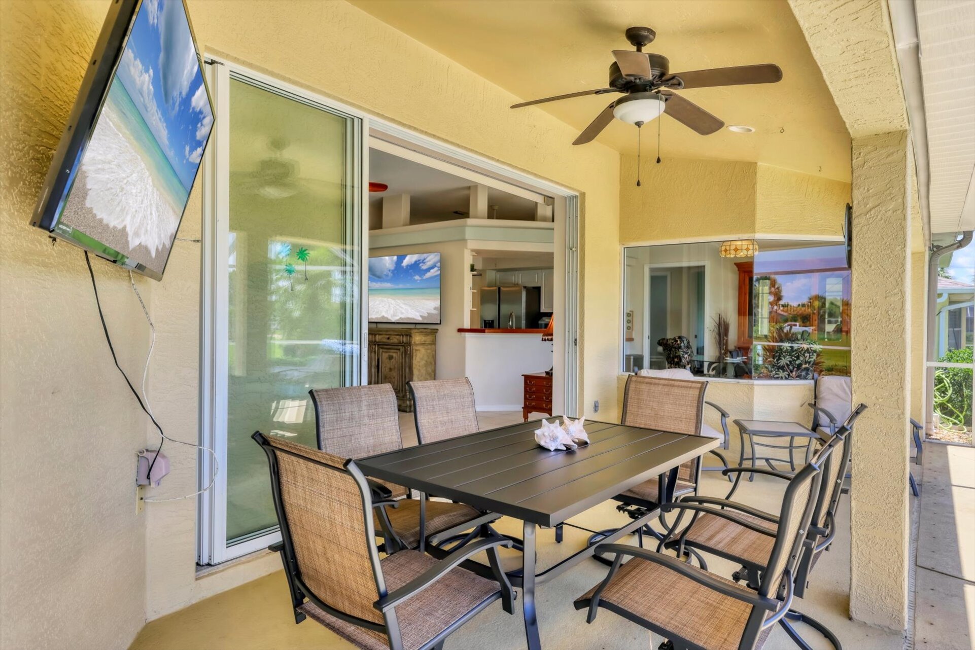 Large outoor living area overlooking the sparkling pool and canal
