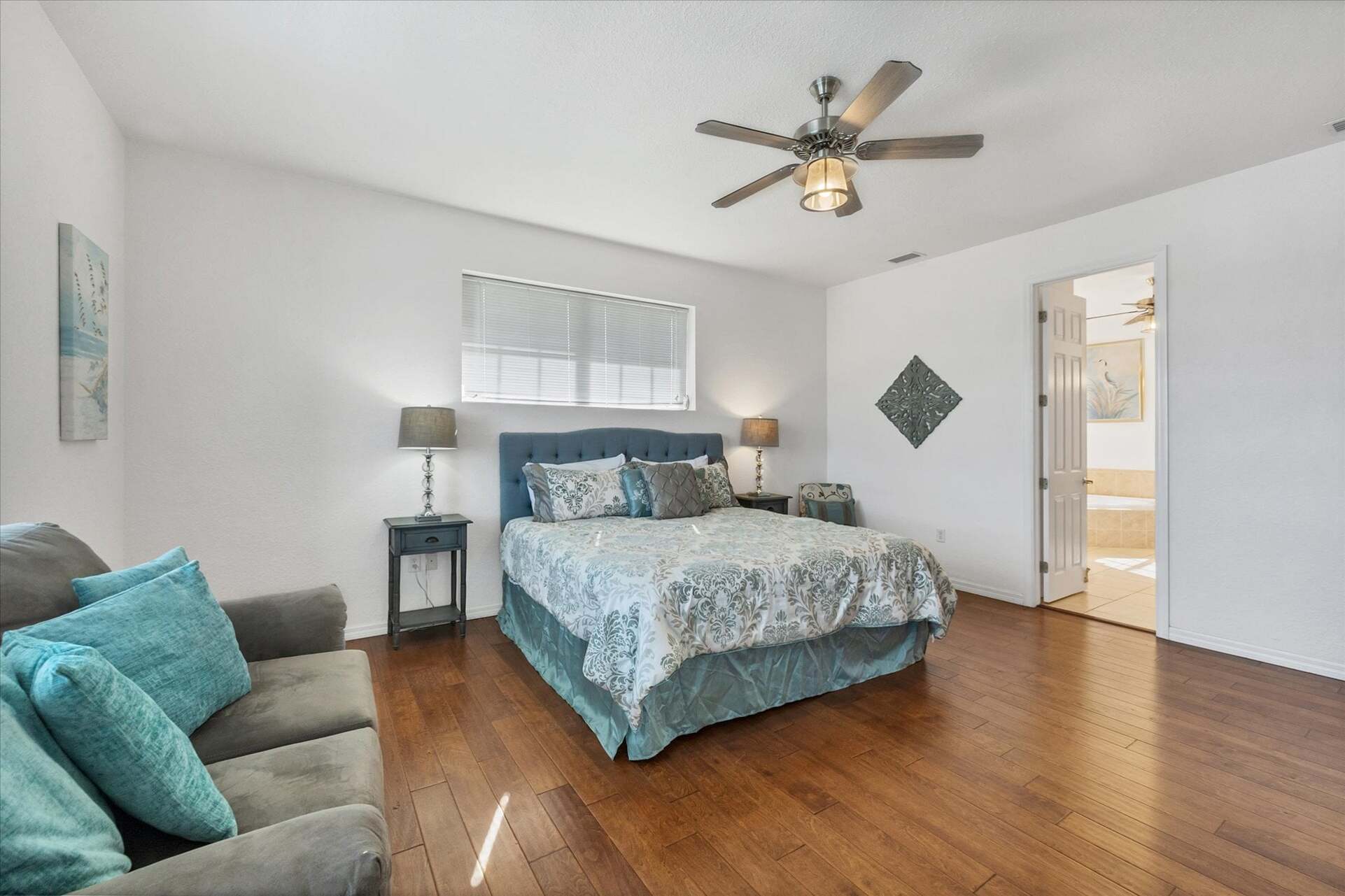 Upstairs primary suite with balcony access, king bed bed and attached bathroom