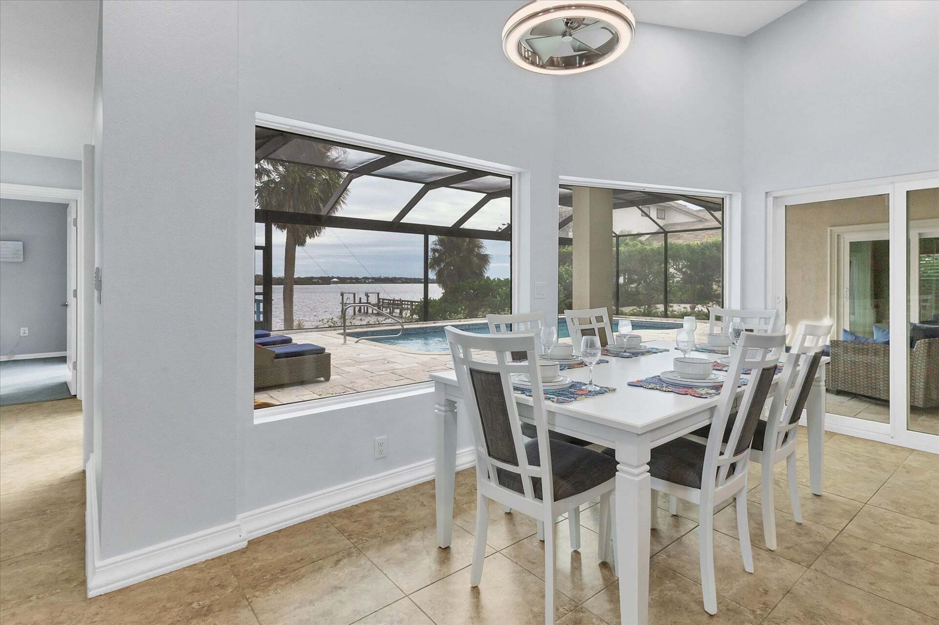 Dining area with water view. Dining table seats six, with additional seating for four at the kitchen island