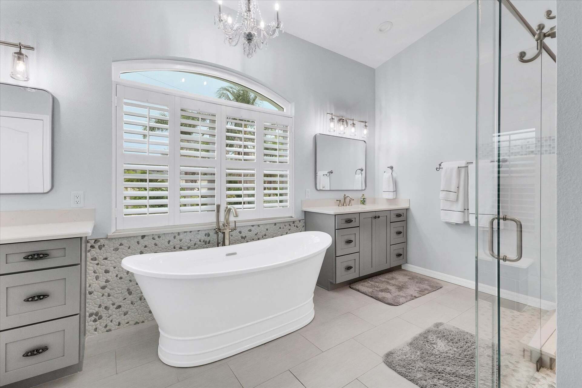Primary en suite with large walk-in shower, soaking tub, and double vanities