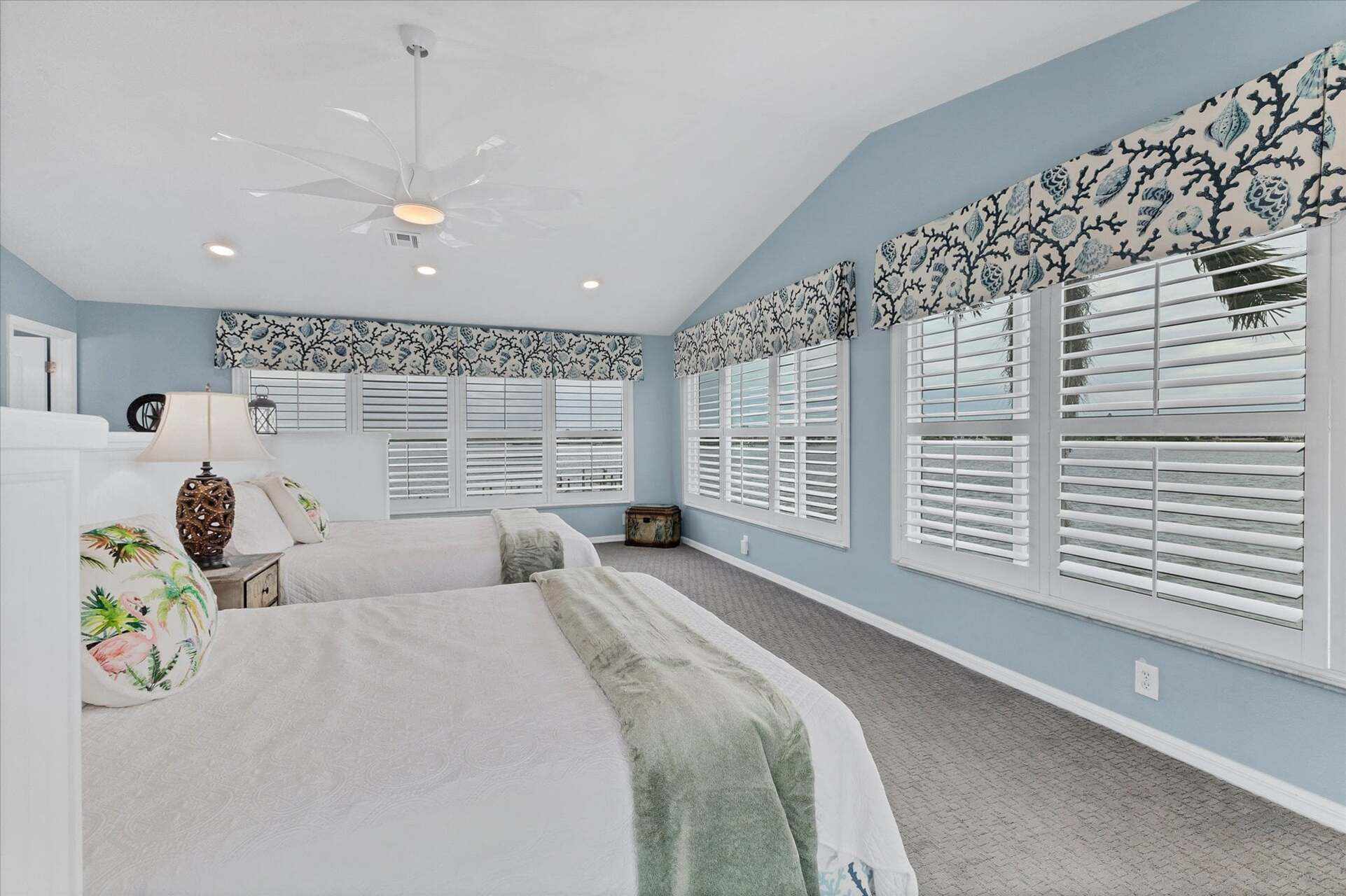 Upstairs guest bedroom features two queen beds, 50-inch Smart TV, attached bathroom, and 160 degree view of Lemon Bay