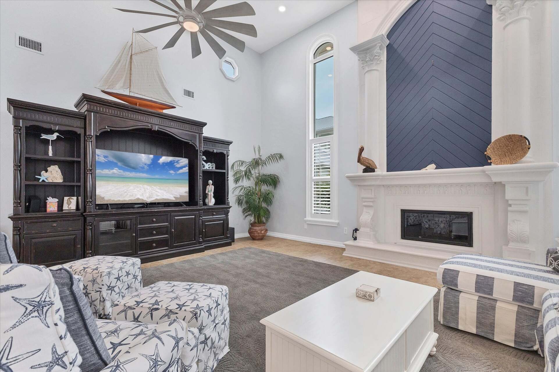 Large, open living space with ample seating, fireplace and 70-inch Smart TV
