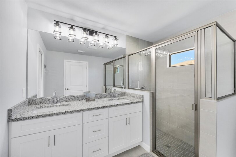 Primary en suite with walk-in shower and double vanities