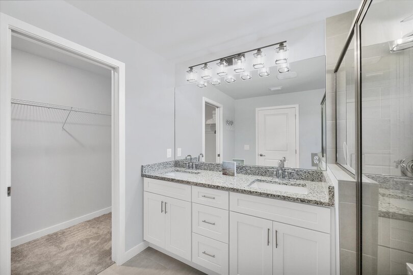 Primary en suite with walk-in shower and double vanities