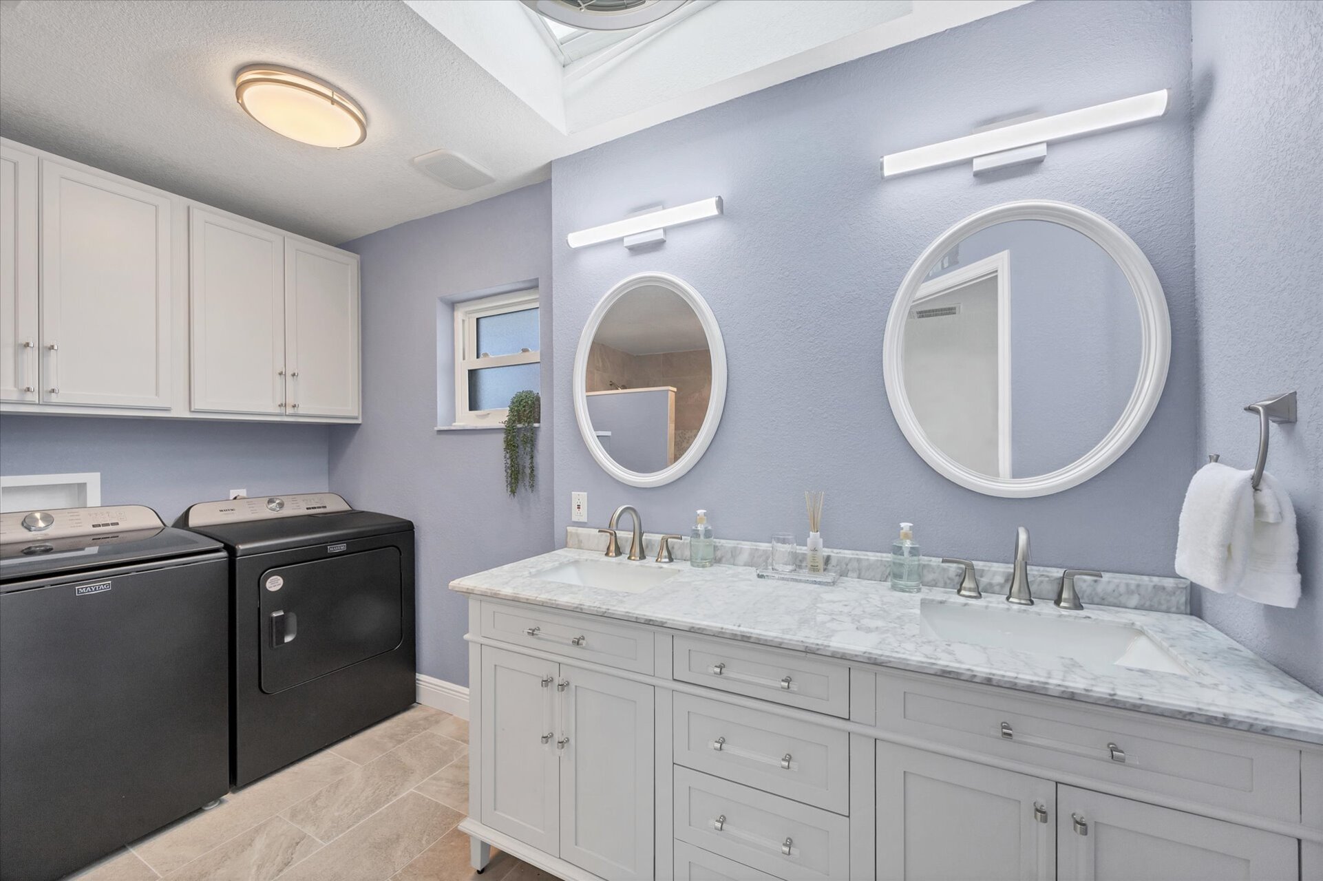 Primary attached bathroom with walk-in shower and double vanities