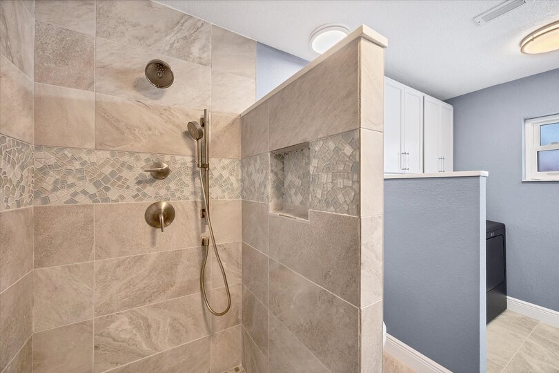 Primary attached bathroom with walk-in shower and double vanities