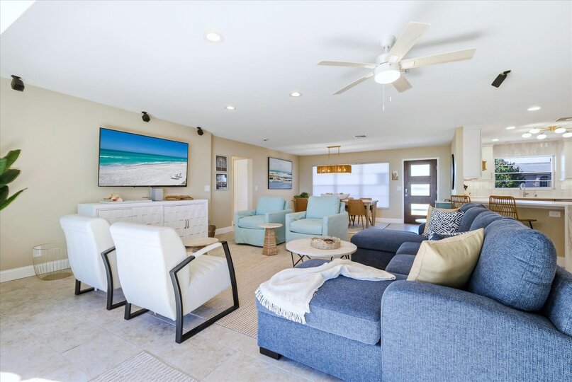 Living room features lots of comfy seating and 70-inch Smart TV
