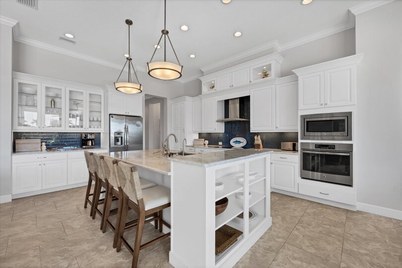 Gorgeous, fully-equipped kitchen over looking the living room and dining areas. Kitchen features lots of countertop & storage space, and stainless-steel appliances. Kitchen island seats 4