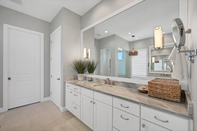 Primary attached bathroom with walk-in shower, soaking tub, and double vanities