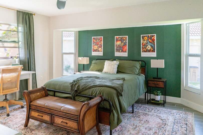 Primary bedroom featuring a queen bed and attached bathroom