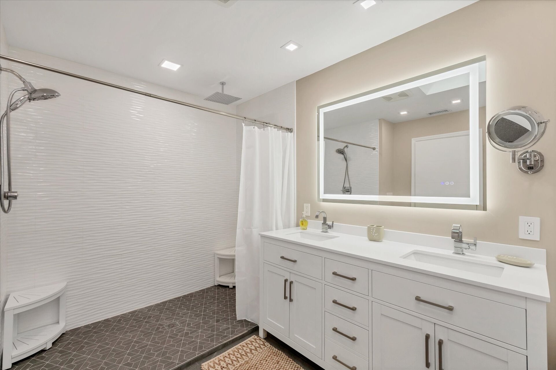 Primary Bathroom with large walk-in shower, double vanities, and bath tub